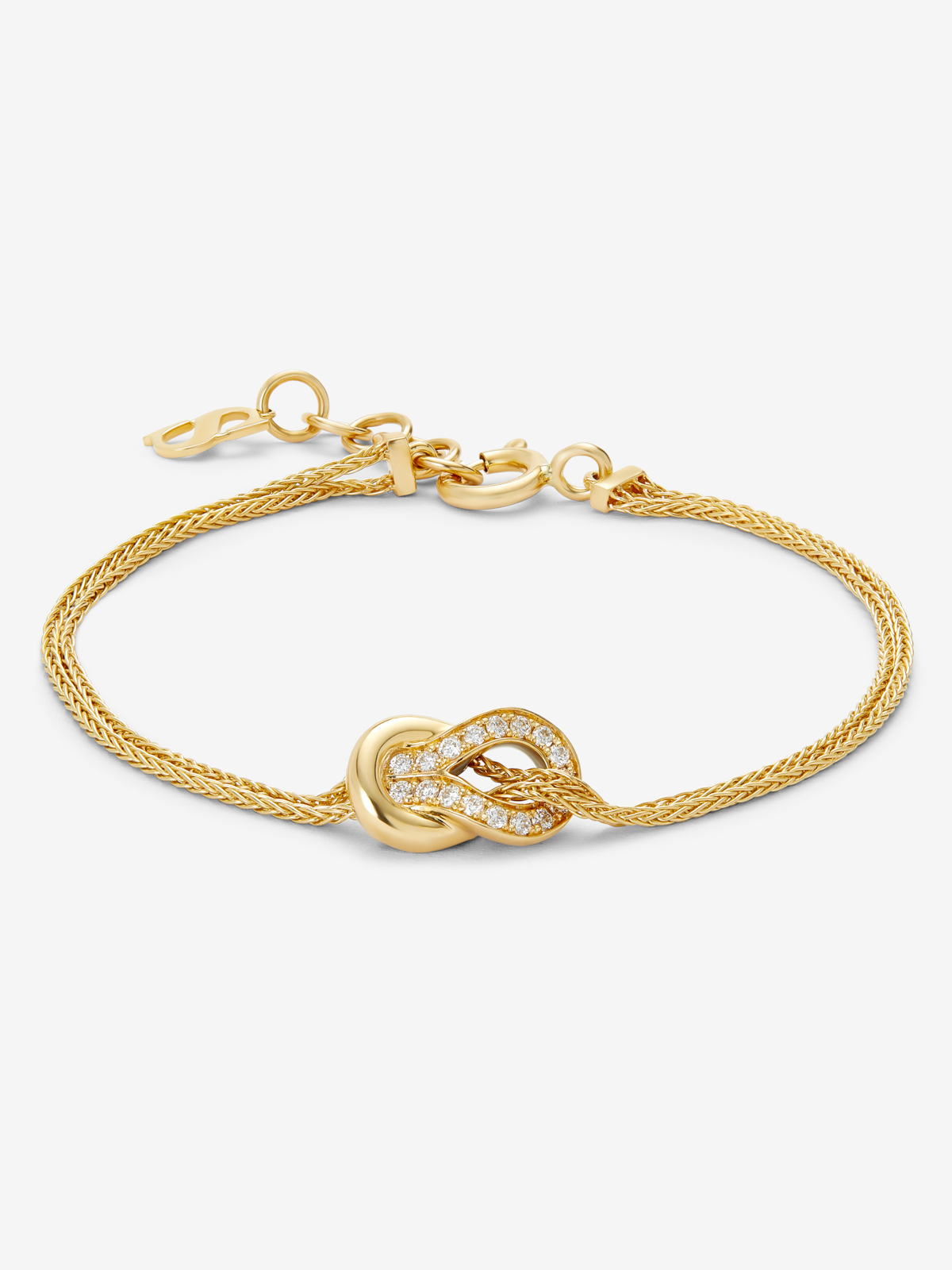 Pulsera de oro amarillo de 18K con 17 diamantes en talla brillante con un total de 0,15 cts y forma de nudo