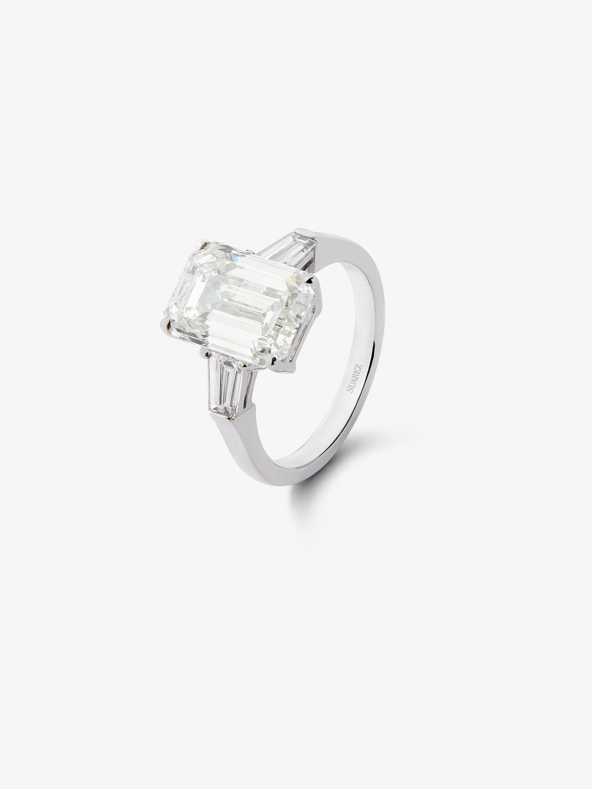 18K white gold triple ring with 5.03 ct emerald cut diamonds and 0.6 ct trapezoid cut diamonds